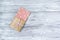 Pink chocolate whole bar decorated with slices of fruit nuts and slices against gray background. Trendy handmade chocolate. Gift