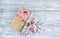 Pink chocolate whole bar decorated with slices of fruit nuts and slices against gray background. Trendy handmade chocolate. Gift