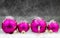 Pink christmas balls on grey background with miniature painter