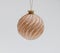 Pink Christmas tree ball ornamented with convex golden stripes