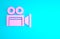 Pink Cinema camera icon isolated on blue background. Video camera. Movie sign. Film projector. Minimalism concept. 3d