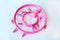 Pink circle plastic clothespins on white background