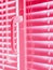 Pink closed horizontal blinds with rope and handle