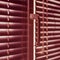 Pink closed horizontal blinds with rope and handle closeup