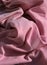Pink cloth table napkins clumped up and wrinkled