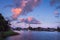 Pink cloudscape over the lake in the summer morning. Amazing scene of colorful sky in countryside lake