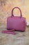 Pink clutch bag isolated on marmor background.Women`s handbag, Ladies bag, Purple female clutch, pink leather clutch