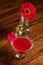 Pink cocktail with a light bulb - vase of red flower