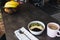 Pink coffee cup, bowl with chopped fruits and blueberries, spoon in kitchen