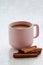 Pink coffee cup with cinnamon stick