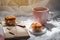 Pink Coffee mugs, snacks and gift box on white fabric background with sunlight.Top view. Coffee in morning holiday breakfast