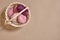 Pink coils of yarn in the basket on a beige background. Top view. Copy space