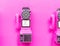 Pink coin payphone on pink wall