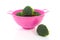 Pink colander with broccoli vegetable