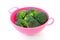 Pink colander with broccoli vegetable