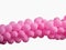 Pink color decorated balloons in a row over white background