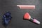 Pink comb, blue scrunchies and pink make up brush on a dark stone surface. Girls cosmetic products, Flat lay
