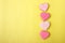 Pink cookie heart shaped with different patterns, yellow background