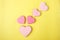 Pink cookie heart shaped with different patterns, yellow background