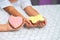 Pink Cookies in the form of a butterfly and heart lie on a children`s hand. The child decorated cookies with cream