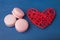 Pink cookies, macaroni and red heart on a blue background.