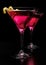 Pink cosmopolitan cocktails isolated on black