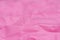 Pink creased color paper texture background selective focus