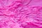 Pink creased tissue papet background texture selective focus macro