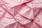 Pink crumpled paper texture abstract background