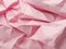 Pink crumpled paper texture abstract background