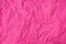Pink crumpled paper texture as background