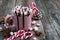 Pink cup with hot chocolate decorated with marshmallows and candy canes