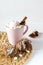 Pink cup of hot cocoa with marshmallows and cookies