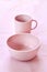 Pink cup and plate on gentle pink background