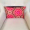 Pink cushion with floral design decorating armchair