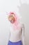 Pink cute girl unicorn on white background. young woman close up portrait. Halloween costume