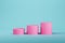 Pink cylindrical pedestal on light blue background for product display