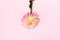 Pink dahlia flower on pastel yellow background. Top view. Flat lay. Copy space. Creative minimalism still life. Floral design