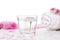 Pink daisy flowers in glass of water and Rolled white towel