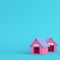 Pink doghouses on bright blue background in pastel colors