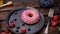 Pink donut with berries, strawberries. Close-up video shooting, dark background