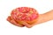 Pink donut in the glaze on the palm, isolated on white background, tasty fresh watered glaze