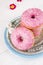Pink donuts in silver and blue plate