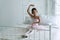 Pink dresses little girl 9 year dancing ballet with white bed in bedroom at home, Ballerina young girl practicing ballet