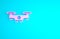 Pink Drone flying icon isolated on blue background. Quadrocopter with video and photo camera symbol. Minimalism concept