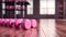 pink dumbbells on wooden floor