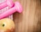 Pink dumbells and apple on wooden table