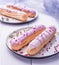 Pink eclairs plate morning light violet French breakfast close up cream