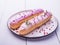 Pink eclairs plate morning light violet French breakfast close up cream cake