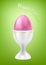 Pink egg in cup. Easter food. Green back.